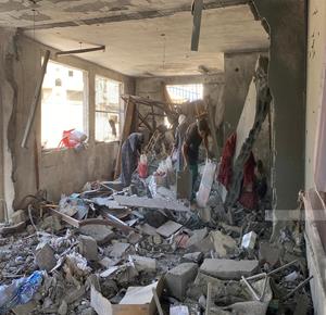 Palestinians inspect the damage to Abdul Fattah Hamoud School, which was targeted by Israeli occupation aircraft, on Jaffa Street in Gaza City.